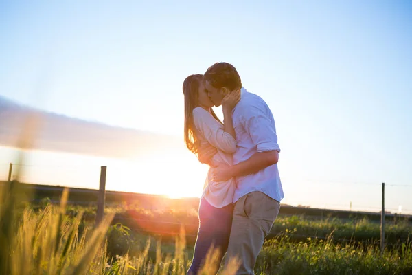 Cariñosa pareja besándose en campo — Foto de Stock