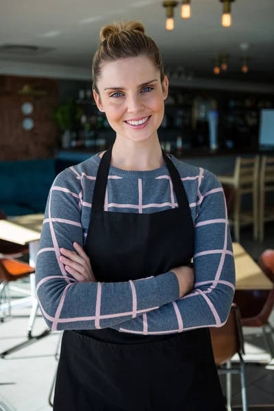 Waitress standing with arms crossed — Stock Photo, Image