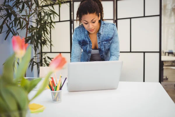 Zakenvrouw met behulp van laptop aan balie — Stockfoto