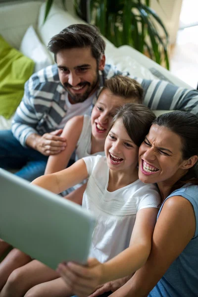 Happy family using digital tablet in the living room — Stockfoto