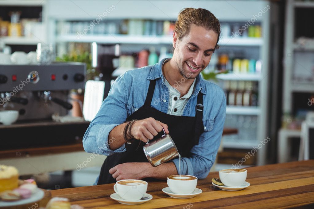 Waiter making cup of coffee at counter Stock Photo by ©Wavebreakmedia
