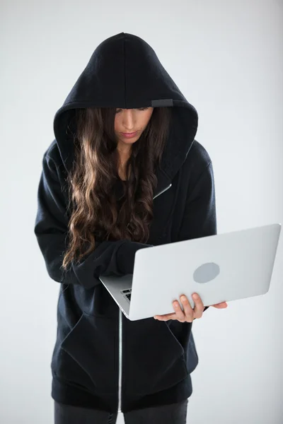 Hacker using a laptop — Stock Photo, Image