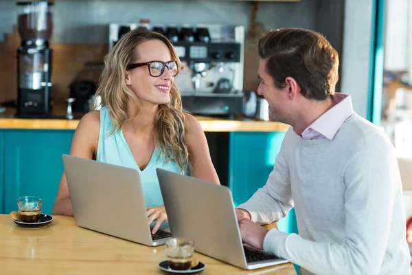 Man and woman using laptop during meeting — Stock Photo, Image