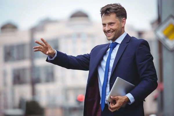 Handsome businessman calling for taxi — Stock Photo, Image