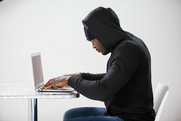 Hacker using a laptop — Stock Photo, Image