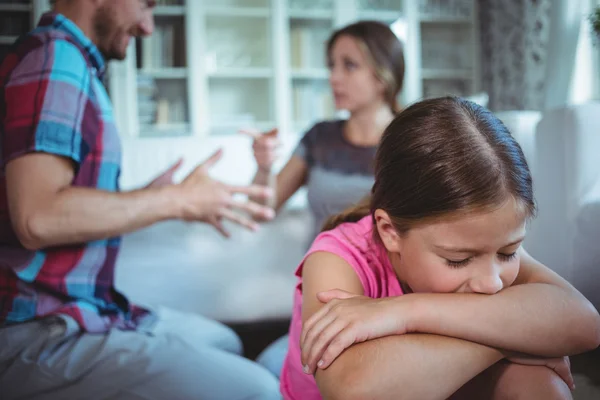 Trauriges Mädchen hört zu, wie ihre Eltern streiten — Stockfoto