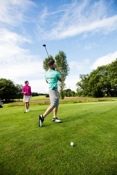 Instrutor masculino assistindo mulher na aprendizagem de golfe — Fotografia de Stock