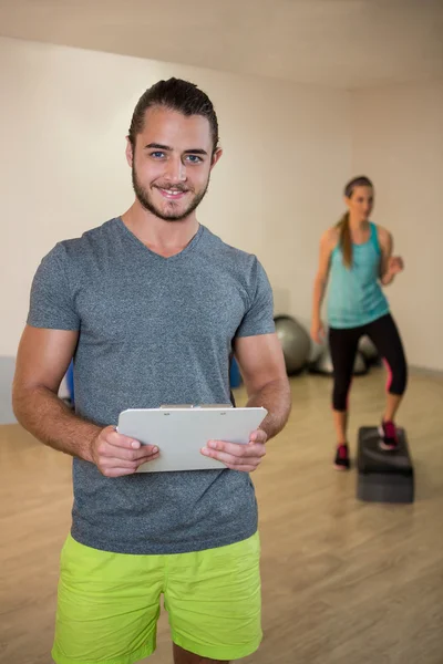 Entrenador de fitness sujetando portapapeles — Foto de Stock