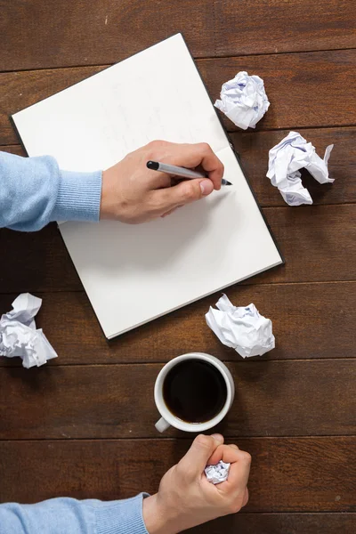 Man crumpling paper while writing — Stock Photo, Image