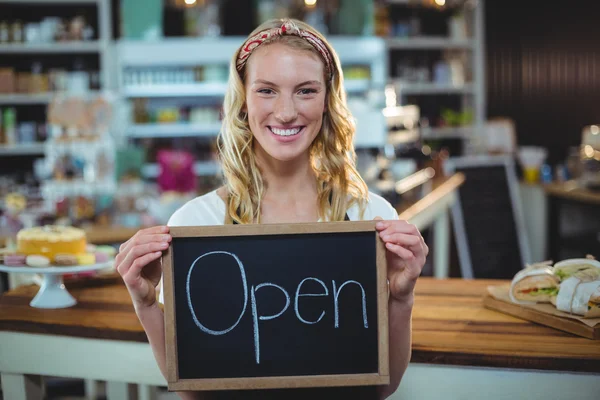 Waitress showing chalkboard with open sign — Stock Photo, Image