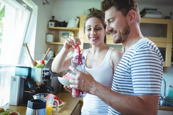Paar bereitet Wassermelonen-Smoothie in Küche zu — Stockfoto