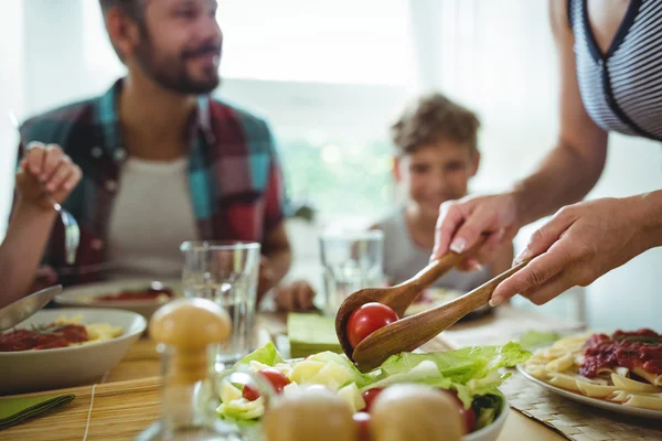 Frau serviert ihrer Familie Mahlzeit — Stockfoto