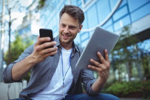 Business executive using phone and tablet — Φωτογραφία Αρχείου