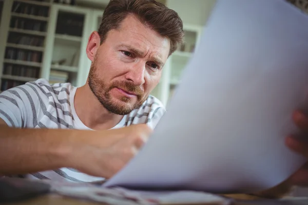 Worried man looking at his bills — Stock Photo, Image