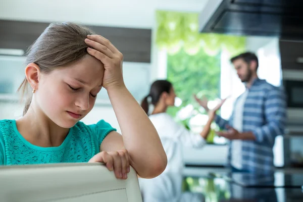 Menina inclinada na cadeira, enquanto os pais discutindo — Fotografia de Stock