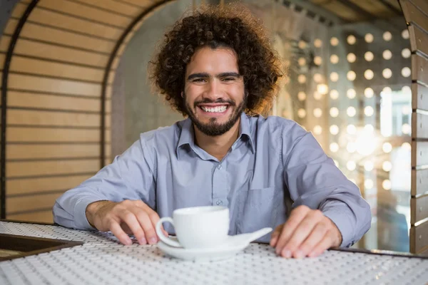 Man sitting on bar counter with tea — Stock Photo, Image