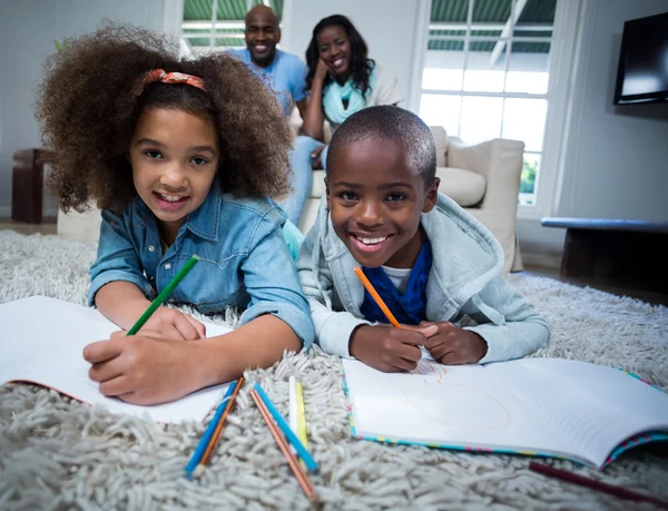 Children doing their homework with parents — Stock Photo, Image