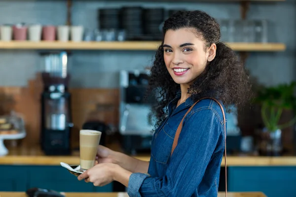 Femme souriante tenant une tasse de café — Photo