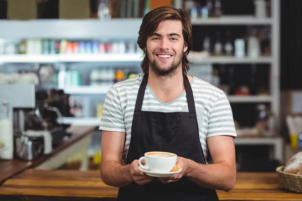 Waiter offering cup of coffee — Stock Photo, Image