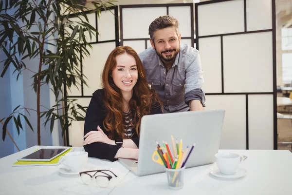 Smiling business people with laptop — Stock Photo, Image