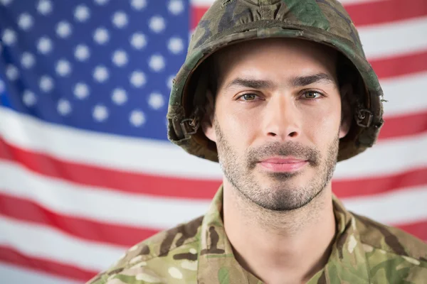 Soldado confiante contra a bandeira americana — Fotografia de Stock