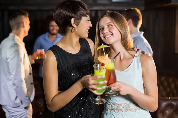 Female friends holding glass of cocktail — Stock Photo, Image