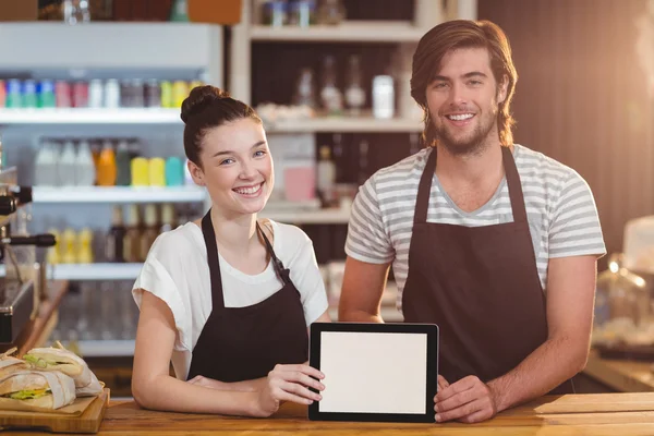 Waiter and waitress using tablet at counter — Stock Photo, Image