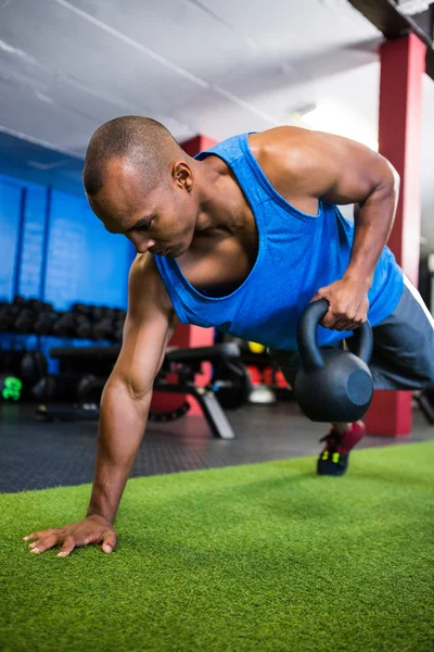 Athlete holding kettlebell in gym — Stock Photo, Image