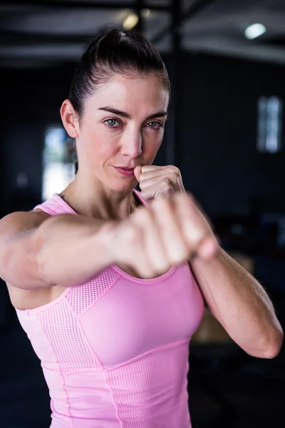 Confident female athlete punching — Stock Photo, Image