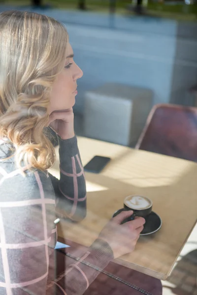 Женщина пьет кофе в столовой — стоковое фото
