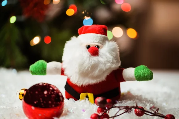 Santa claus and christmas ornaments on snow — Stock Photo, Image