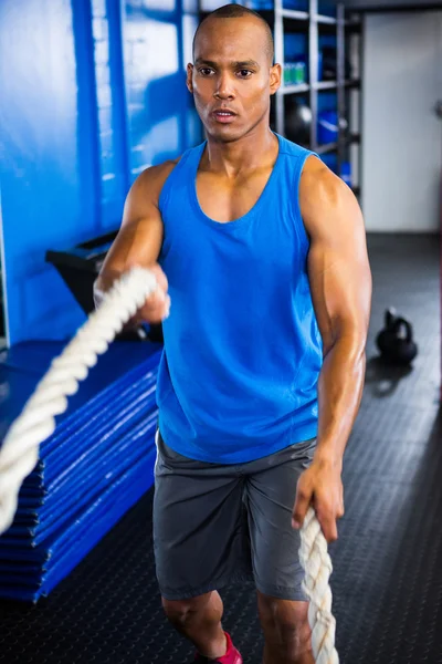 Determined male athlete exercising with ropes — Stock Photo, Image