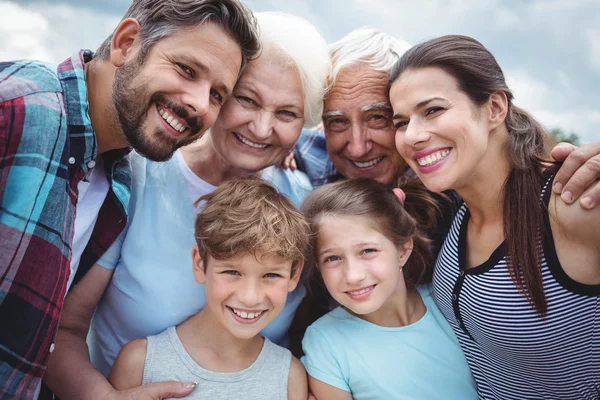 Multi-generation family standing  outdoors — ストック写真