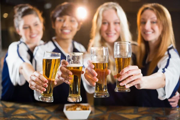 Friends holding glass of beer in party — Stock Photo, Image