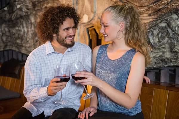 Couple toasting glass of wine in bar — Stock Photo, Image