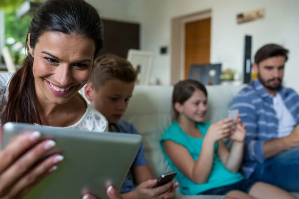 Family using laptop and mobile phone — Φωτογραφία Αρχείου