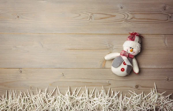 Snowman and small candles on wooden table — Stock Photo, Image