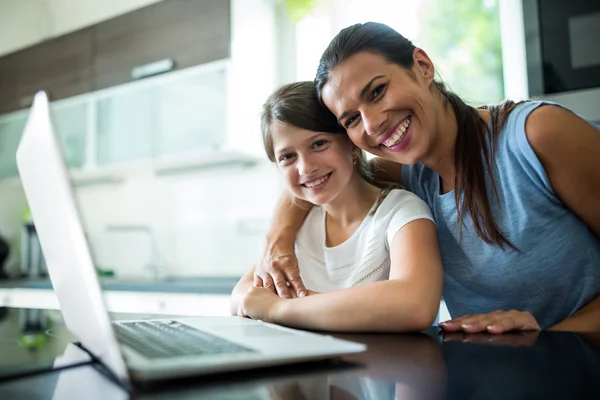 Portrait of mother and daughter using laptop and digital tablet in the living room — Φωτογραφία Αρχείου