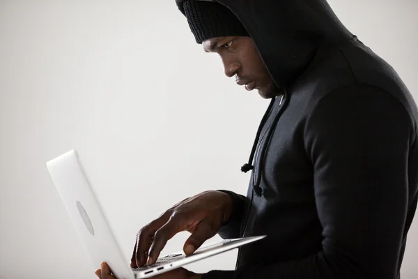 Hacker using a laptop — Stock Photo, Image