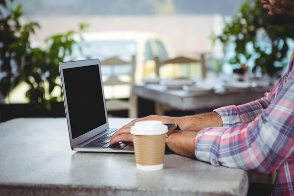 Mid-section of man using laptop — Stock Photo, Image