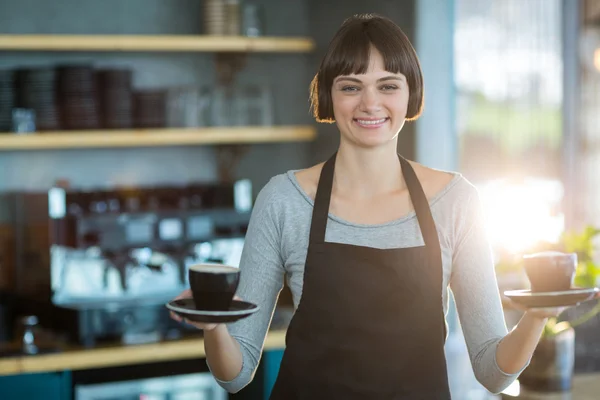 Waitress holding cup of coffee — Stock Photo, Image