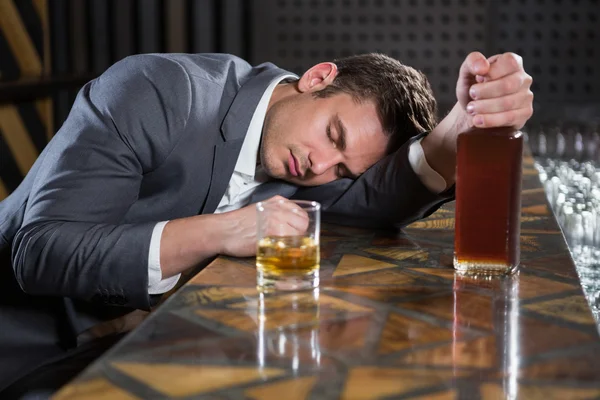 Drunk man lying on a counter — Stock Photo, Image