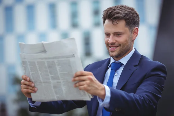 Handsome businessman reading newspaper — Stock Photo, Image