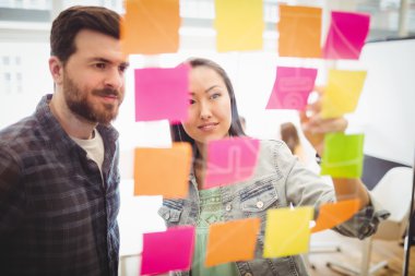 Photo editors looking at sticky notes  clipart