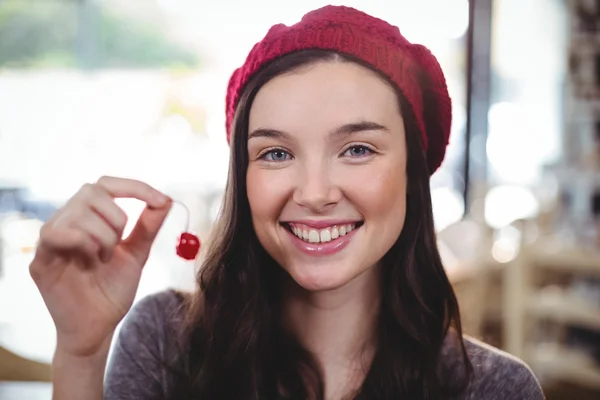 Smiling woman holding cherry — Stock Photo, Image