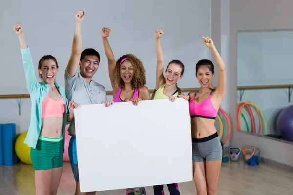 Fitness team holding blank placard — Stock Photo, Image