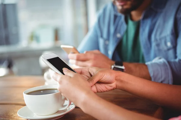 Hands of couple using mobile phones — Stock Photo, Image