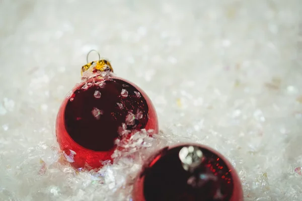 Close-up of christmas baubles on snow — Stock Photo, Image