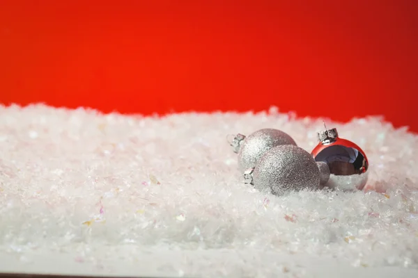 Three christmas baubles on snow — Stock Photo, Image