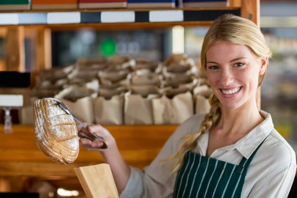 Staff packing bread in paper bag — Stock Photo, Image